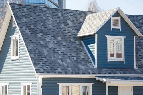 Home with a newly installed architectural shingle roof by Israel's Creations Designs